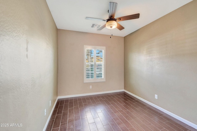 empty room with dark wood-type flooring and ceiling fan