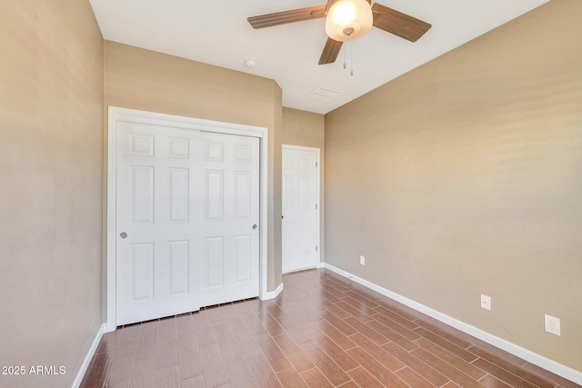 unfurnished bedroom featuring ceiling fan and a closet