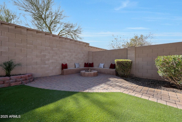 view of yard with a patio and an outdoor fire pit