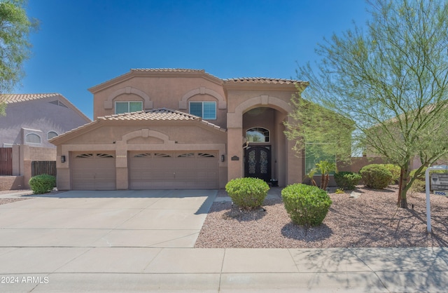 mediterranean / spanish-style home featuring a garage