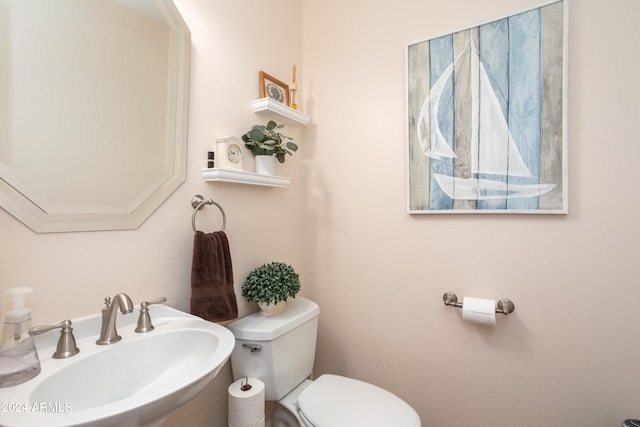 bathroom with toilet and sink