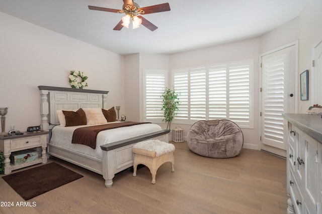 bedroom with light hardwood / wood-style floors and ceiling fan