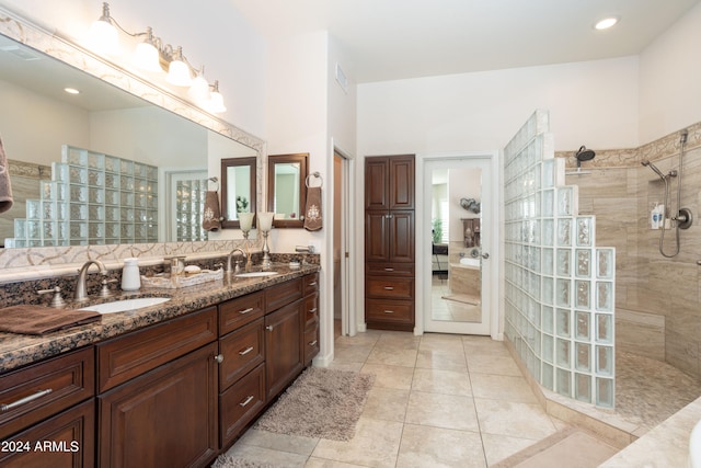 bathroom featuring vanity, tiled shower, and tile patterned floors