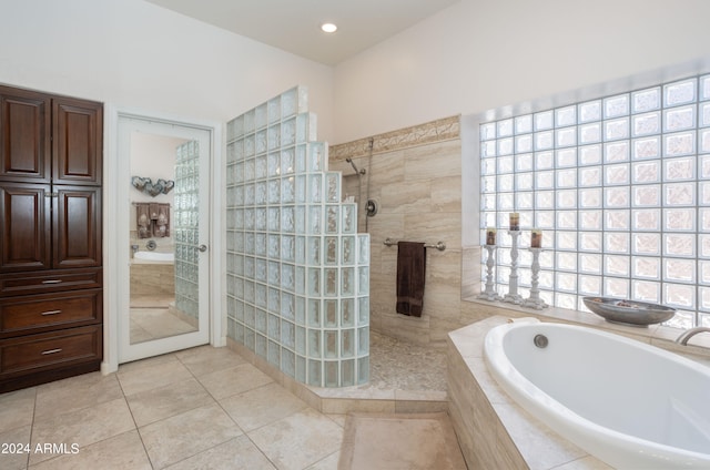 bathroom with tile patterned flooring and independent shower and bath