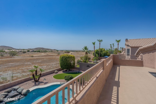 view of patio / terrace featuring a mountain view and a fenced in pool