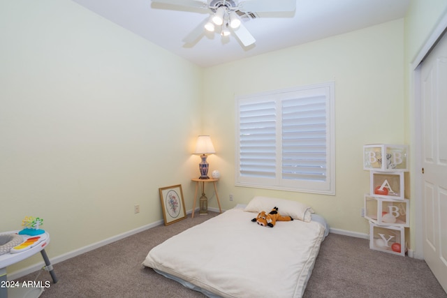 bedroom with a closet, ceiling fan, and carpet flooring