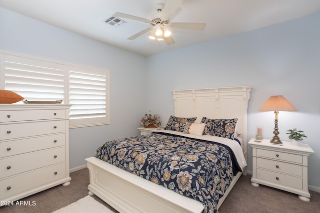 bedroom with dark colored carpet and ceiling fan