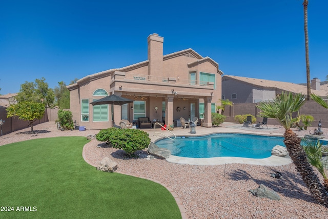 view of swimming pool with a yard and a patio area