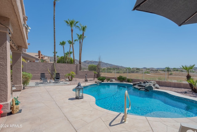 view of pool with a mountain view and a patio area