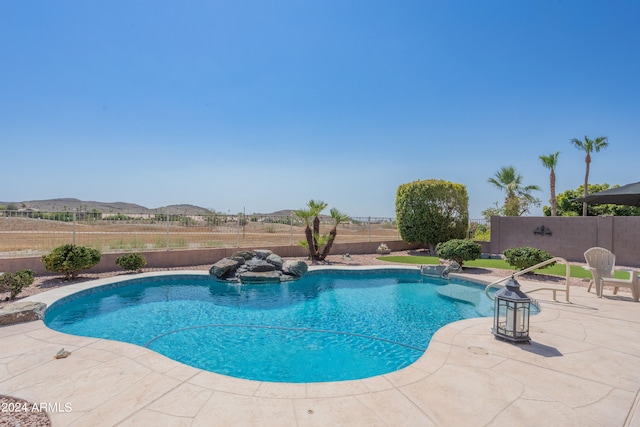 view of pool with a mountain view and a patio