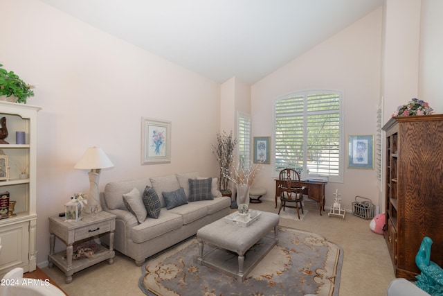 living room with light colored carpet and high vaulted ceiling