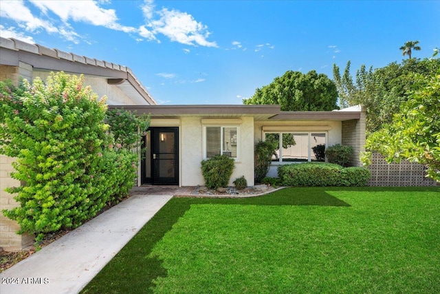 view of front of property with a front lawn and stucco siding