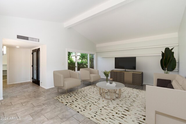 living room with beamed ceiling and high vaulted ceiling