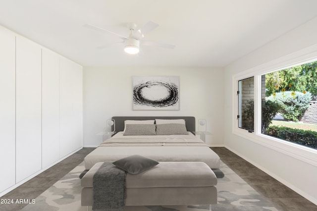 bedroom featuring a ceiling fan and baseboards