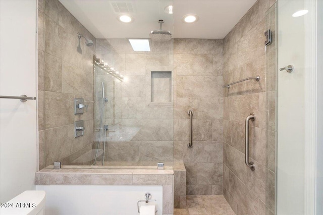 full bath featuring toilet, a stall shower, and visible vents