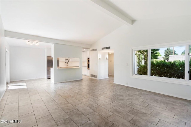 unfurnished living room featuring beamed ceiling, a chandelier, light tile patterned floors, and high vaulted ceiling