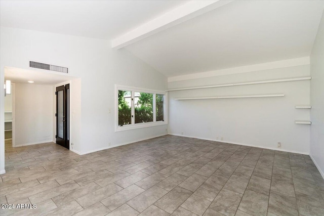 tiled spare room featuring beamed ceiling and high vaulted ceiling