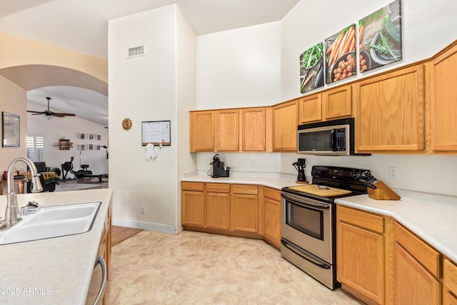 kitchen featuring sink, high vaulted ceiling, stainless steel appliances, and ceiling fan