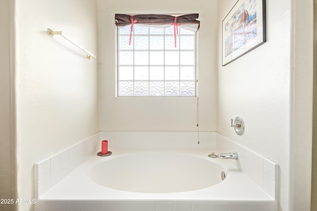 bathroom featuring tiled bath