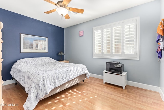 bedroom featuring light hardwood / wood-style flooring and ceiling fan