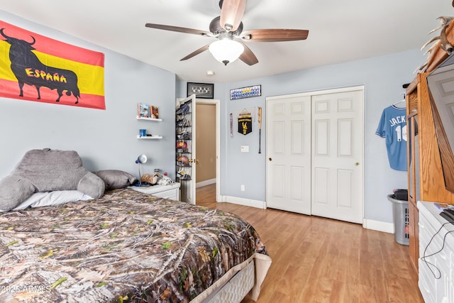 bedroom with ceiling fan, light hardwood / wood-style flooring, and a closet