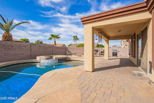 view of swimming pool with a patio, an in ground hot tub, and a grill