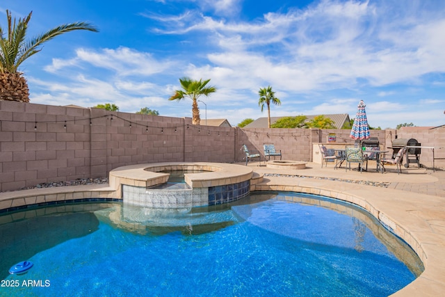 view of swimming pool with a patio, an in ground hot tub, and grilling area