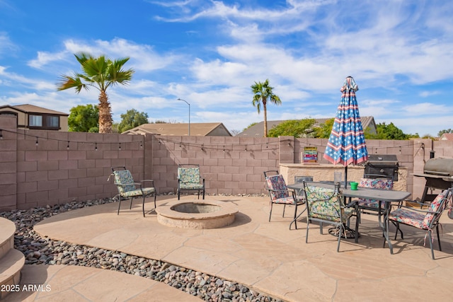 view of patio featuring an outdoor fire pit and a grill