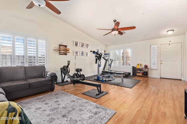 workout room featuring hardwood / wood-style flooring, ceiling fan, and vaulted ceiling