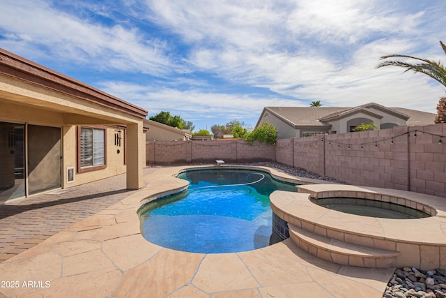 view of swimming pool with an in ground hot tub and a patio area