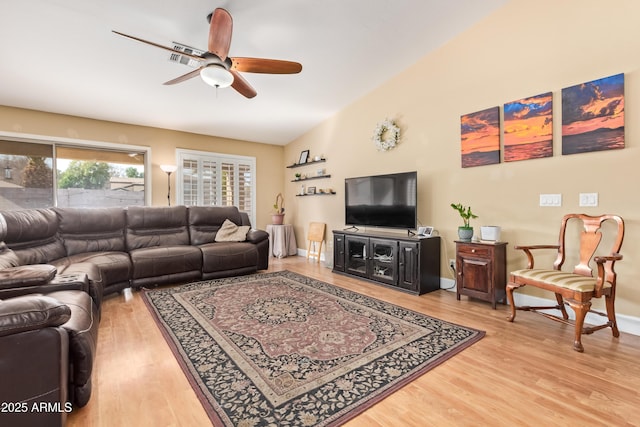 living room with ceiling fan, lofted ceiling, and wood-type flooring