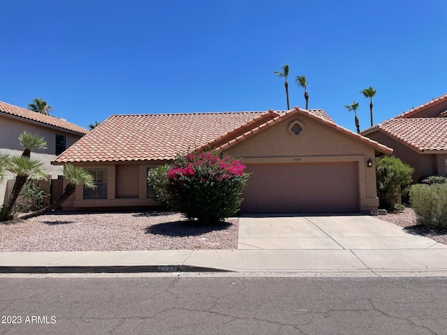 2723 E Rockledge Rd, Phoenix, AZ 85048 - mediterranean / spanish-style home with concrete driveway, a garage, stucco siding, and a tile roof