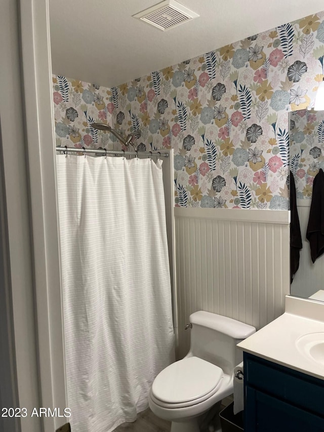 2723 E Rockledge Rd, Phoenix, AZ 85048 - full bath with wallpapered walls, vanity, wainscoting, and a shower with shower curtain