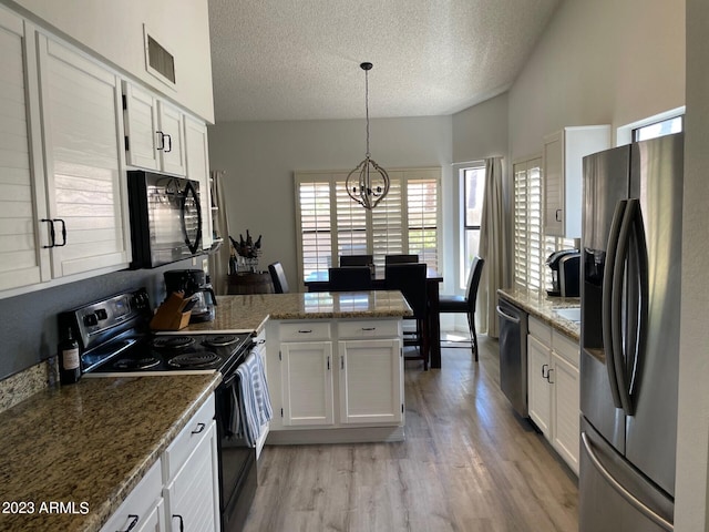 2723 E Rockledge Rd, Phoenix, AZ 85048 - kitchen with black appliances, a peninsula, a textured ceiling, a chandelier, and light wood-style floors
