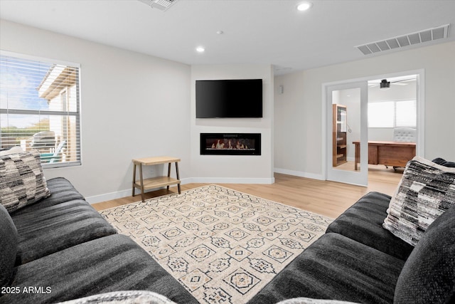 35360 N 93rd Way, Scottsdale, AZ 85262 - living room with a glass covered fireplace, wood finished floors, recessed lighting, and baseboards