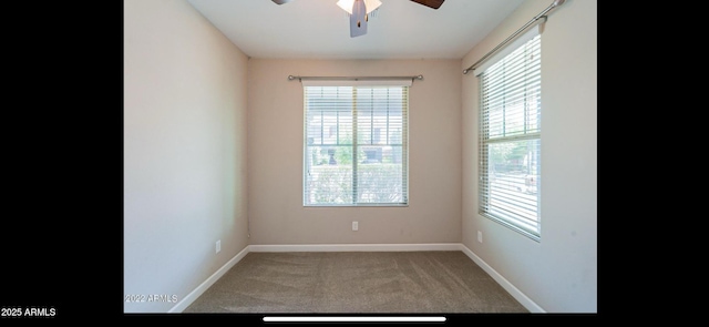 carpeted empty room with baseboards and ceiling fan