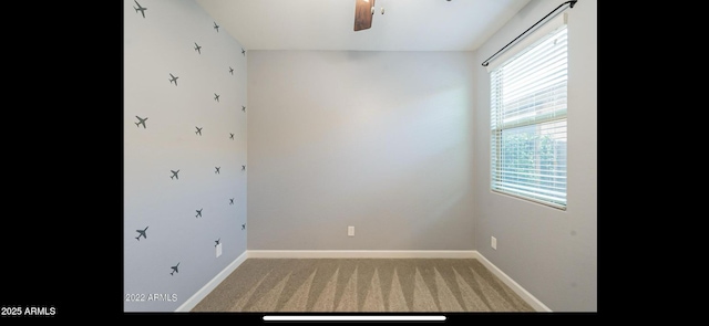 empty room featuring light carpet, ceiling fan, and baseboards