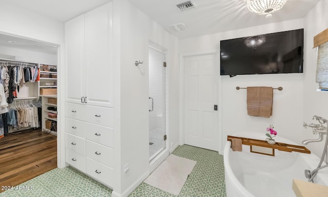 bathroom featuring hardwood / wood-style flooring and a shower with shower door