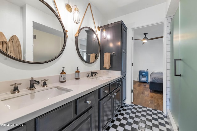 bathroom with hardwood / wood-style floors, ceiling fan, and vanity