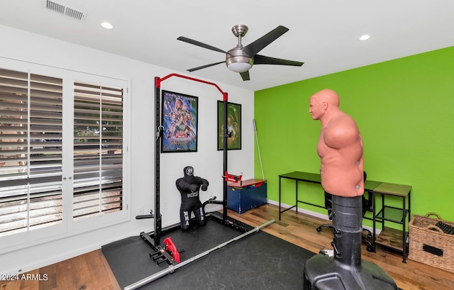 workout room with plenty of natural light, ceiling fan, and dark wood-type flooring