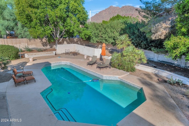 view of pool featuring a patio area and a mountain view