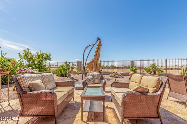 view of patio / terrace featuring an outdoor living space and fence