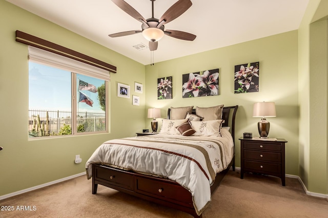 carpeted bedroom featuring visible vents, a ceiling fan, and baseboards