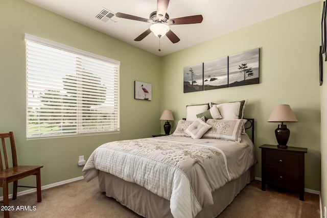 carpeted bedroom with visible vents, ceiling fan, and baseboards