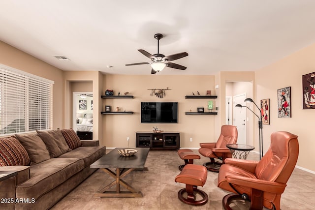 living room featuring tile patterned flooring, baseboards, visible vents, and ceiling fan