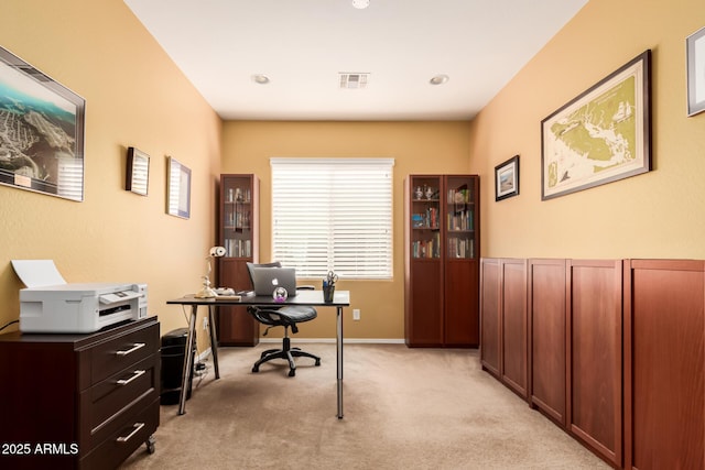 home office featuring visible vents, baseboards, and light colored carpet