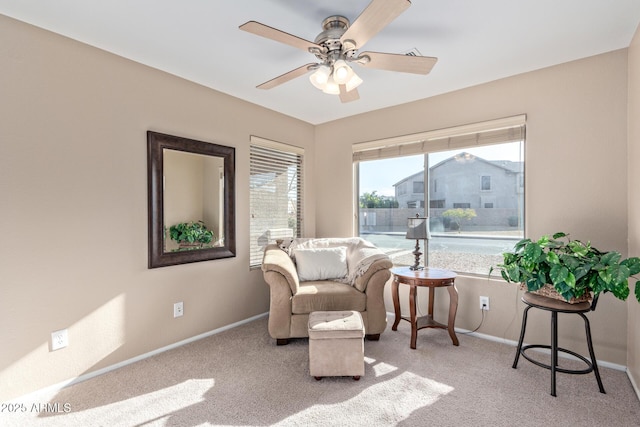 sitting room featuring ceiling fan and light colored carpet