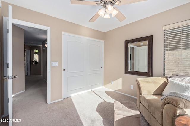 interior space featuring ceiling fan and light carpet