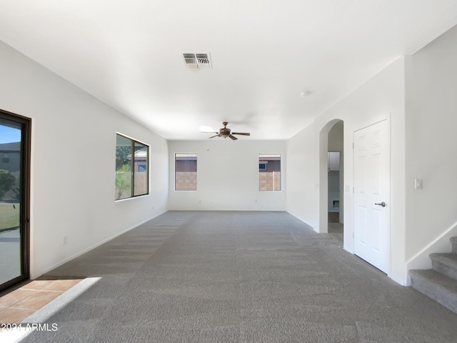 empty room featuring ceiling fan and carpet floors