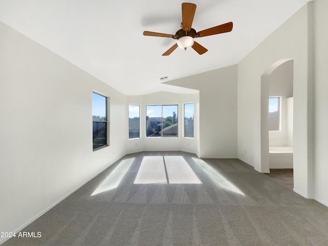 unfurnished room with ceiling fan, light carpet, and vaulted ceiling